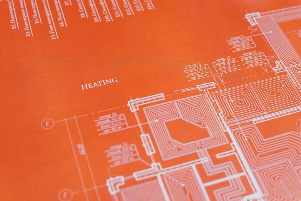 electrical certification documents and blueprint on desk