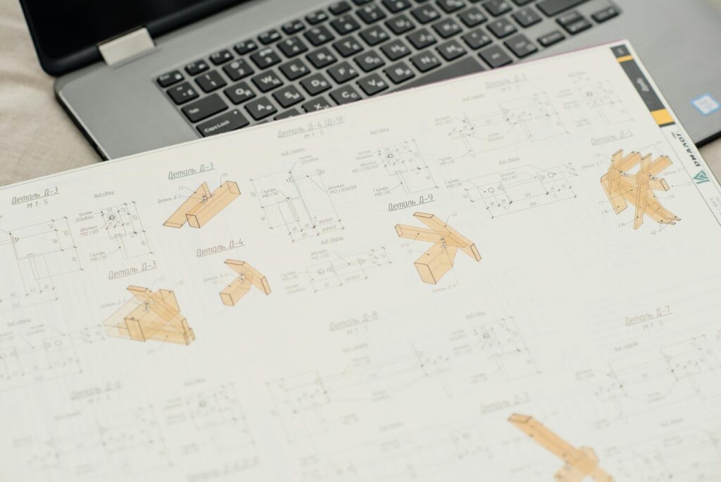 electrical certification documents on desk with blueprint background