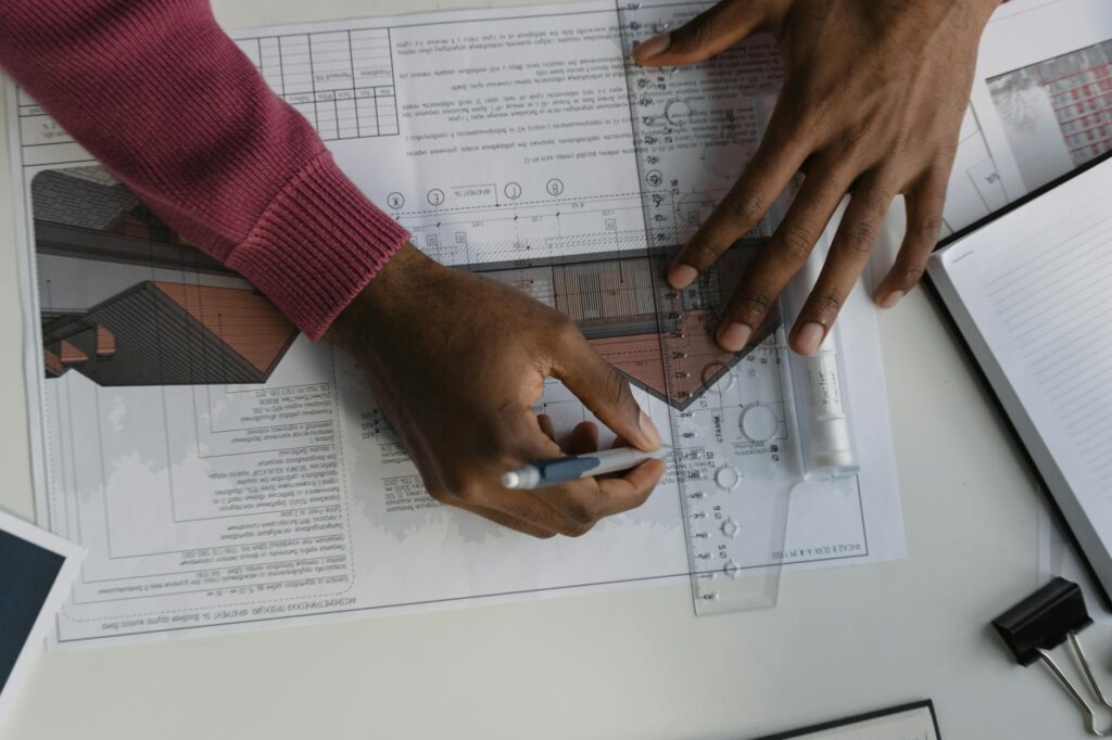 electrical inspection paperwork and blueprint on desk