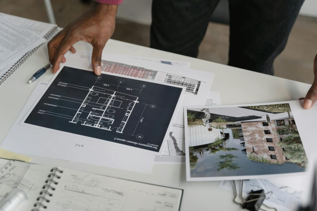 electrical wiring diagram and certification documents on desk with blueprint background