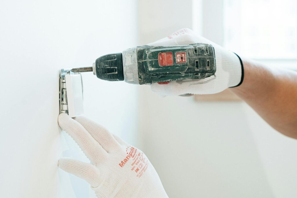 electrician inspecting electrical certification documents and meter installation on a work desk