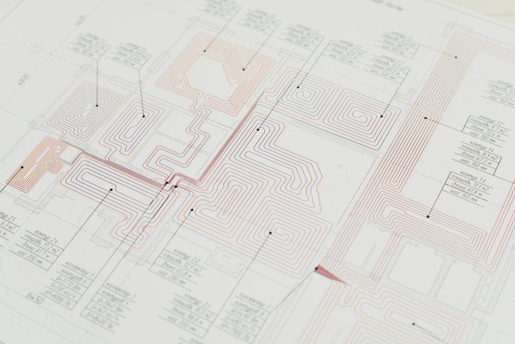electrician reviewing certification documents and circuit diagram on desk