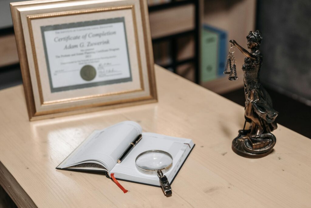 electrical certification documents on desk with wiring blueprint background