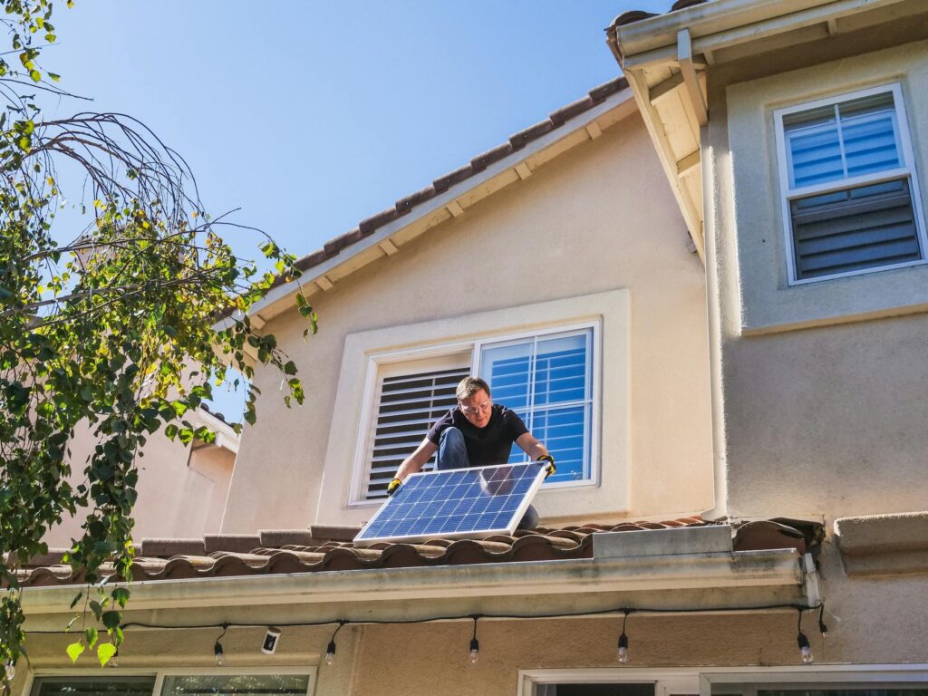 electrician inspecting residential electrical panel and documents
