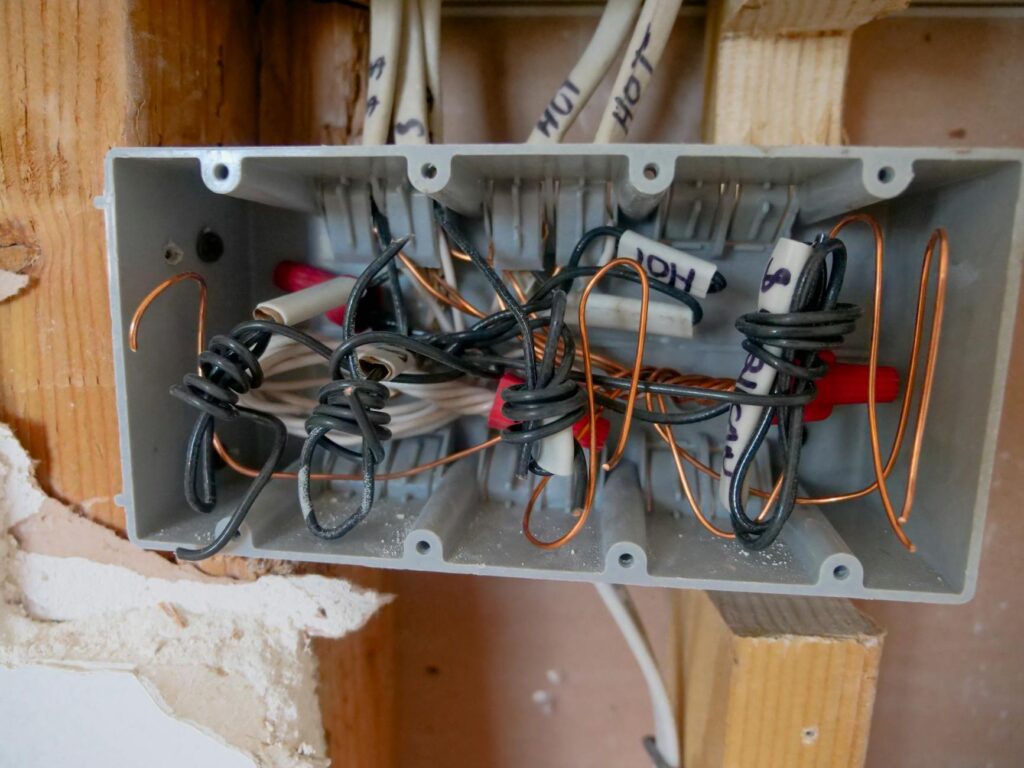 electrician reviewing electrical certification documents and panel