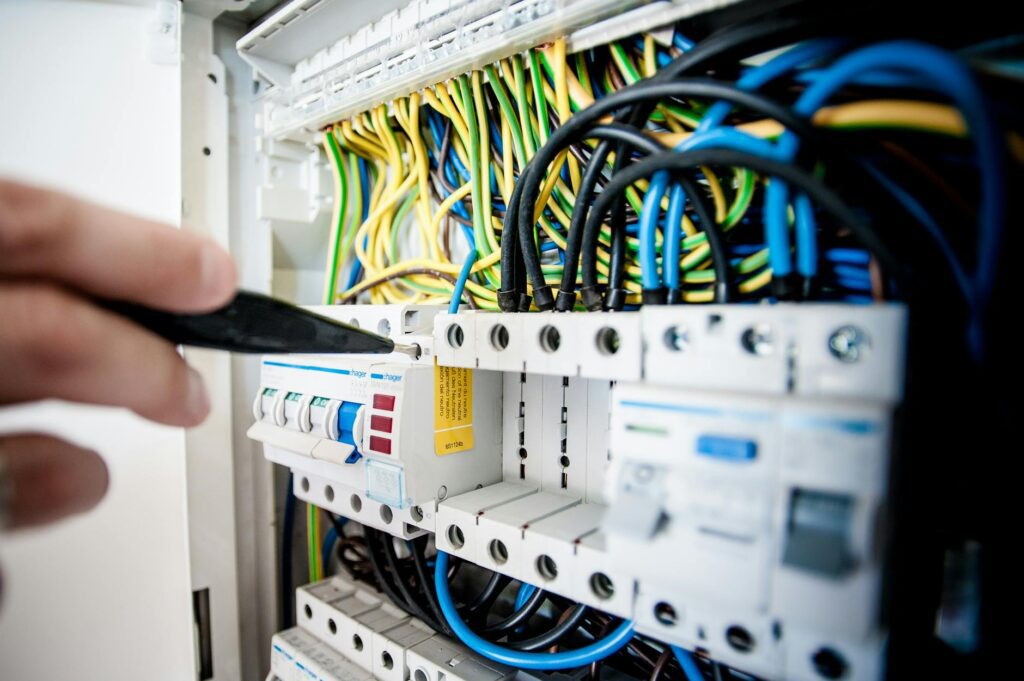 certified electrician inspecting home electrical panel with SNI cable and safety certificate